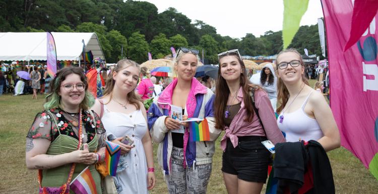 Five young people at a festival dressed in bright colours.