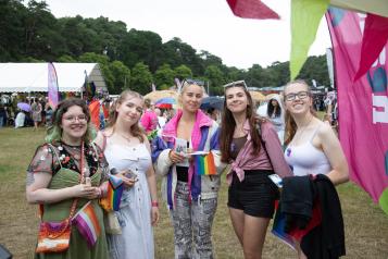 Five young people at a festival dressed in bright colours.